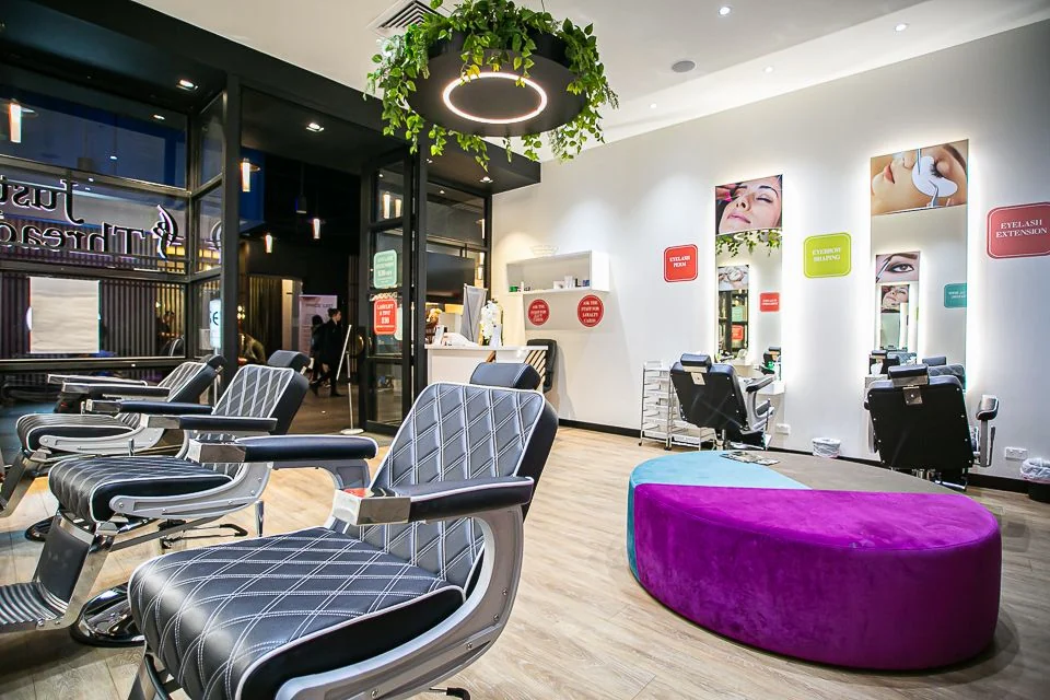 Belle Brow Bar salon interior — treatment chairs, ring light, mirror stations