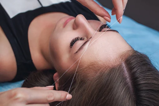 Eyebrow threading in progress